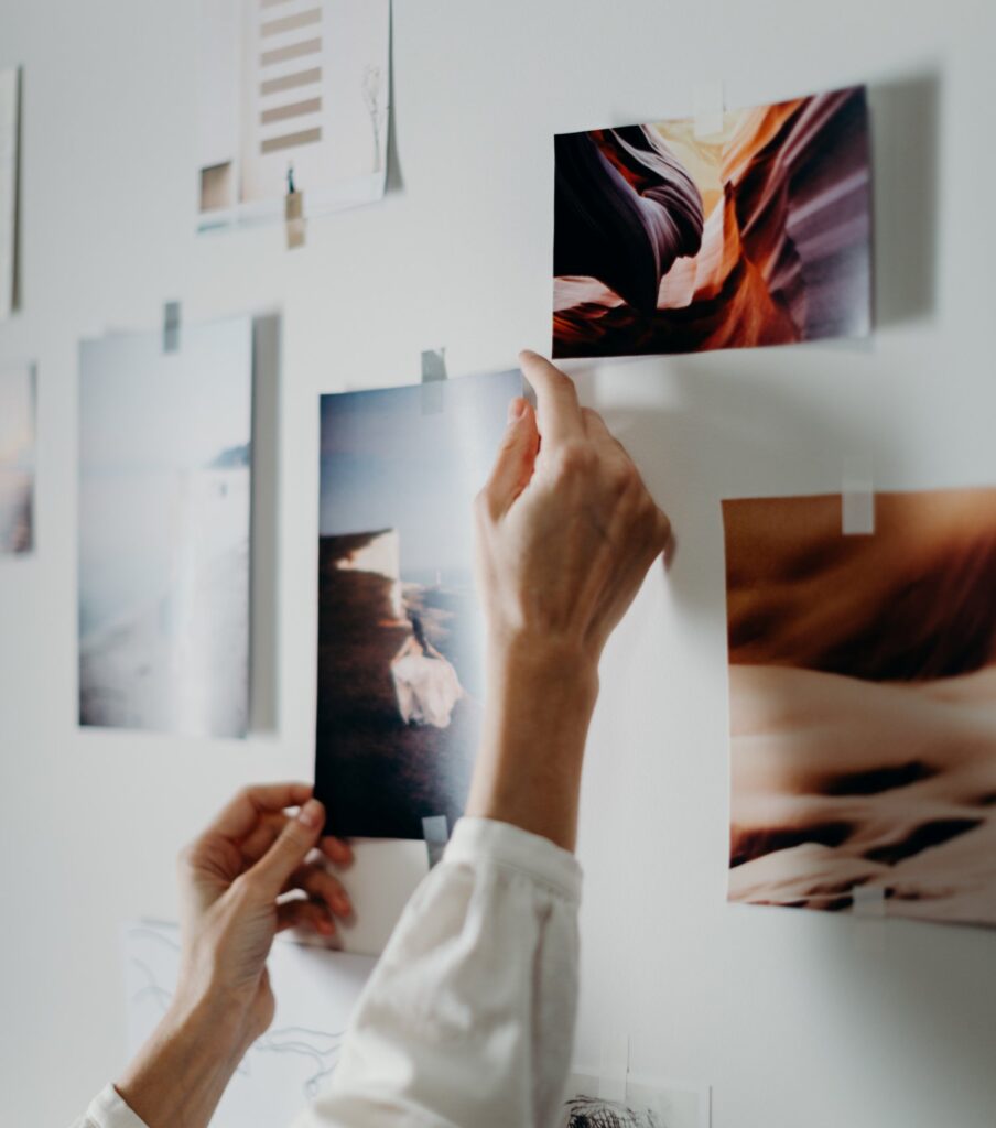 A woman sticks images on a vision board.
